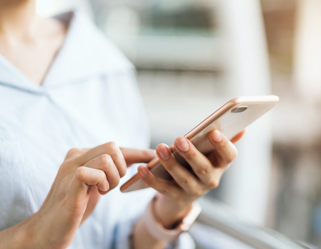 woman using smartphone on staircase in public areas, During leisure time. The concept of using the phone is essential in everyday life